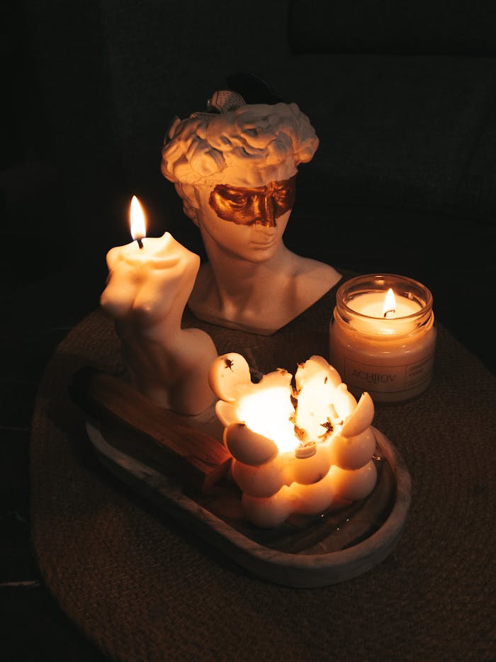 about-01 Artistic candle display with sculptural wax designs and a classical bust.