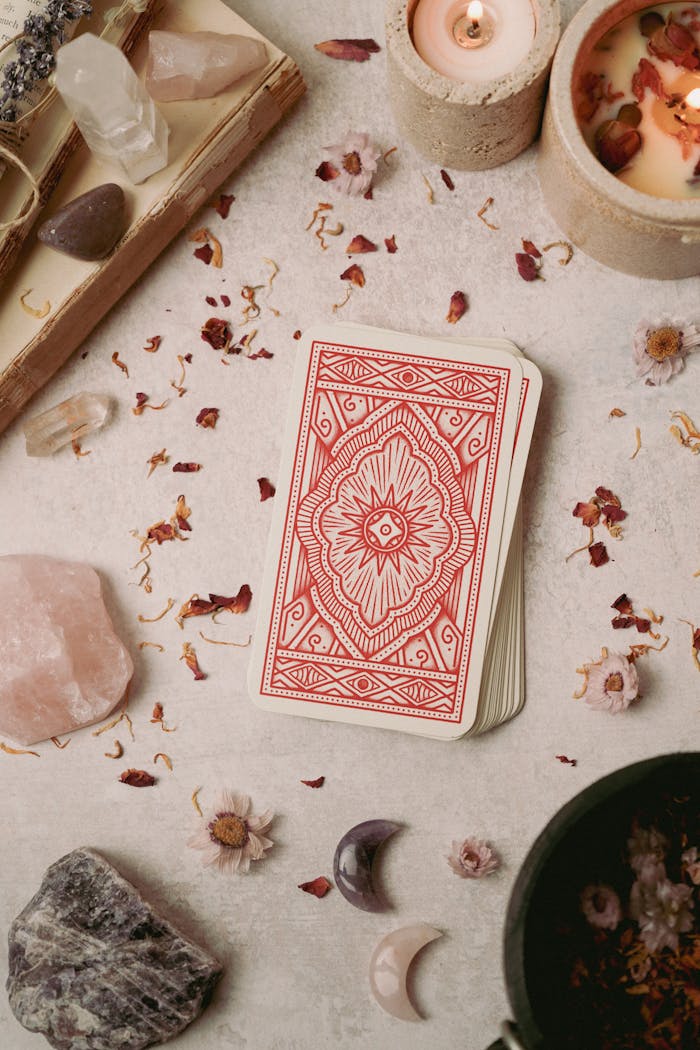 why-choose-us Flat lay of tarot cards surrounded by crystals and candles, evoking a mystical and calming atmosphere.